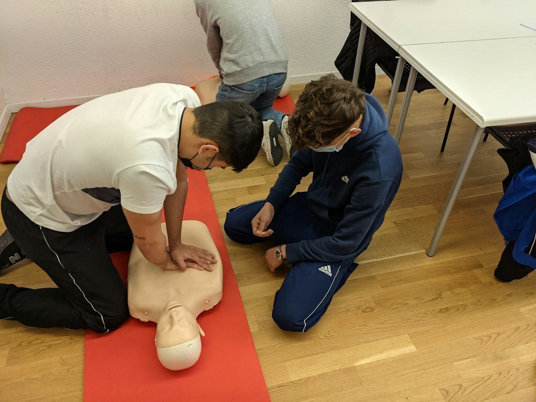 Staff practising CPR during first aid training