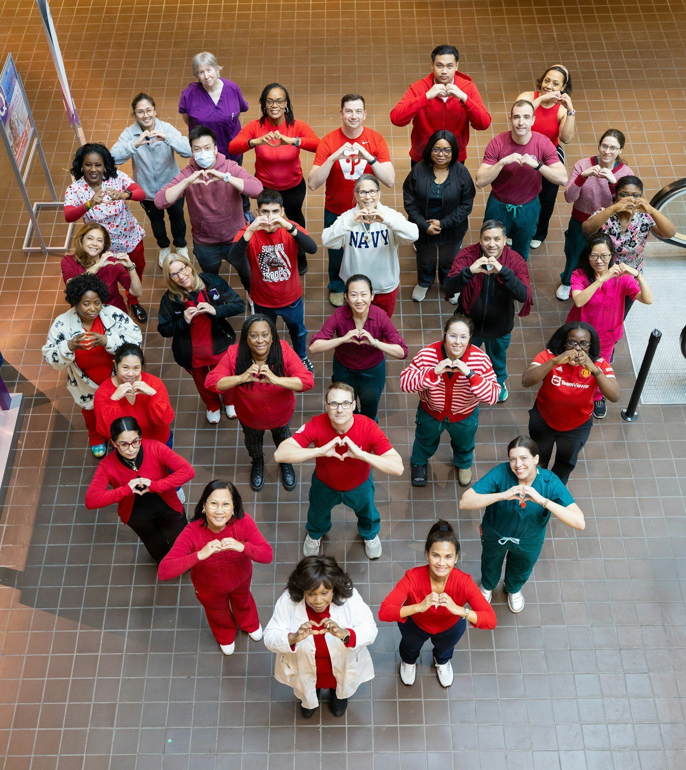 Nursing team forming heart shapes during Nursing Week